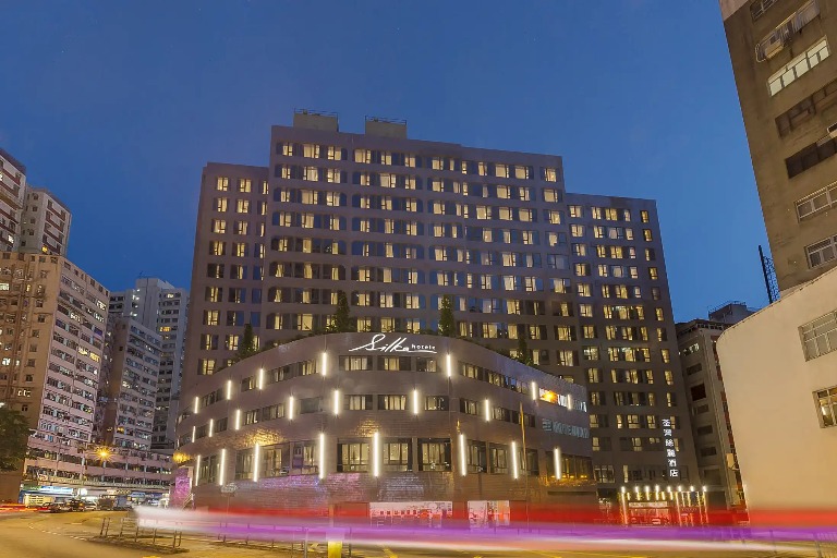 Exterior with name signage of Silka Tsuen Wan Hotel at night