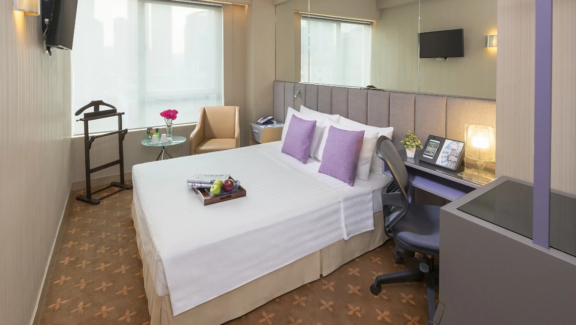 Silka Far East Deluxe Room amenities with fruits and newspapers