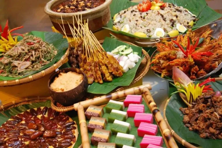 Traditional Malaysian buffet of satay, kue lapis, and more