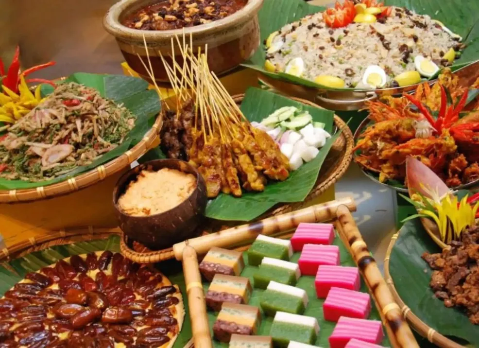 Traditional Malaysian buffet of satay, kue lapis, and more