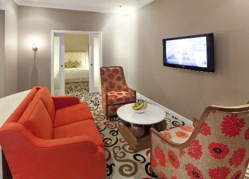 Living area featuring a TV at Silka Maytower Suite