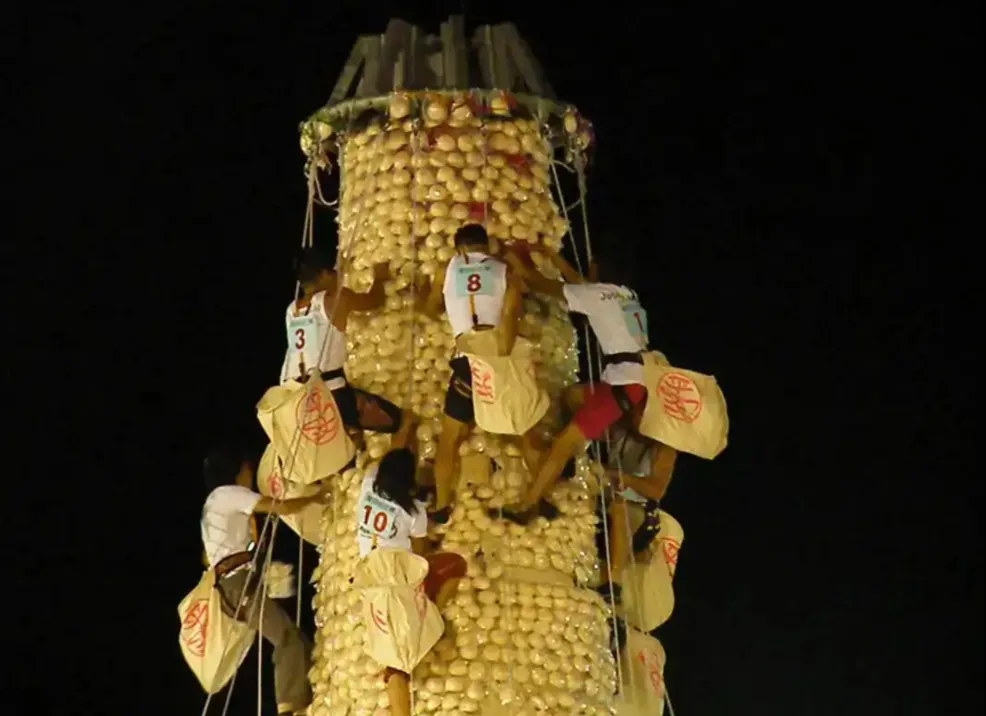 People competing at Cheung Chau Bun Festival, Hong Kong