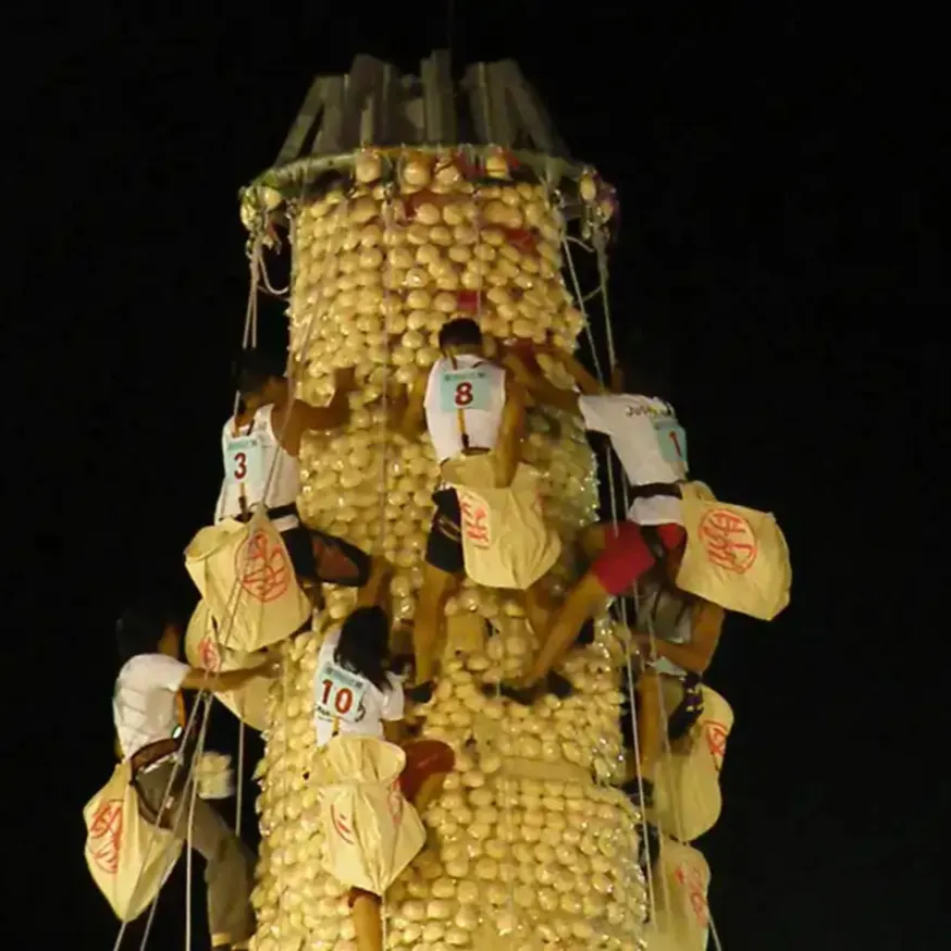 People competing at Cheung Chau Bun Festival, Hong Kong