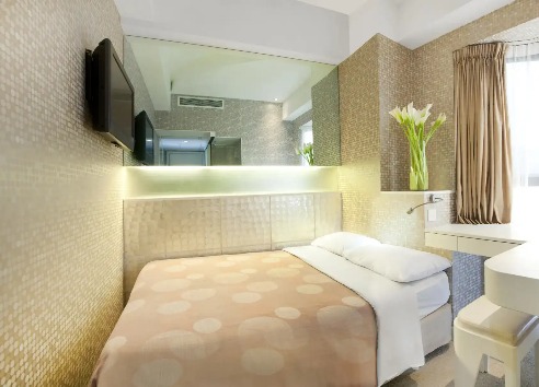 Double bed by window at Silka Sea View Superior Room