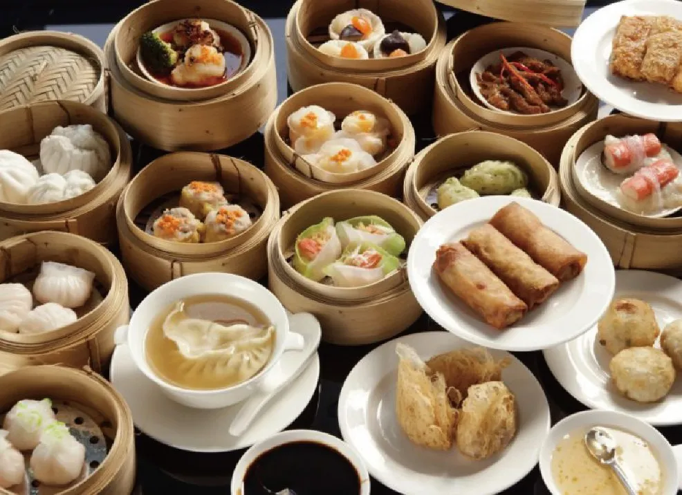 Assorted authentic dim sum served in traditional containers