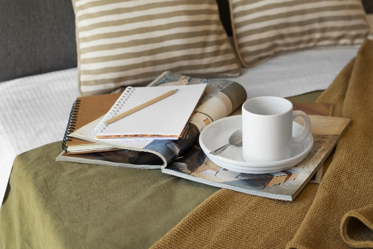 Reading nook on bed with coffee and books at Silka Tseun Wan