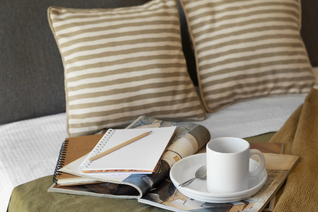 Reading nook on bed with coffee and books at Silka Tseun Wan