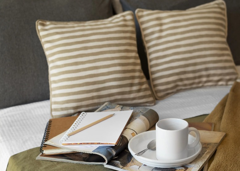 Reading nook on bed with coffee and books at Silka Tseun Wan